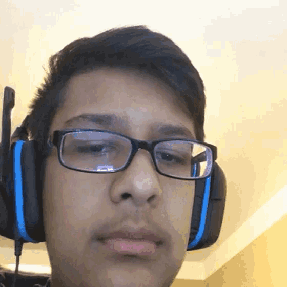 a young man wearing glasses and headphones with a microphone