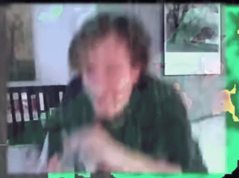a blurry picture of a man in a green shirt with a green background