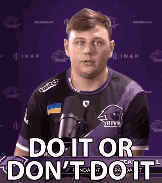 a man speaking into a microphone with the words " do it or don 't do it " above him