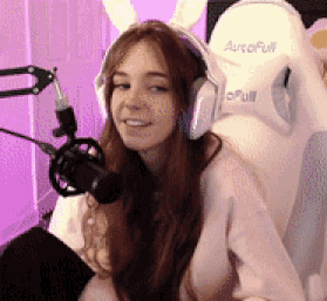 a woman wearing bunny ears and headphones is sitting in a white autofull chair