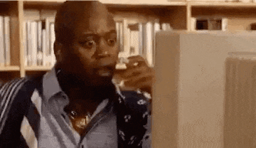 a man is sitting in front of a computer screen .