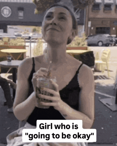 a woman holding a drink with the words " girl who is going to be okay " on the bottom