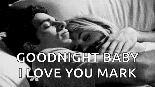 a man and a woman are hugging each other in bed .