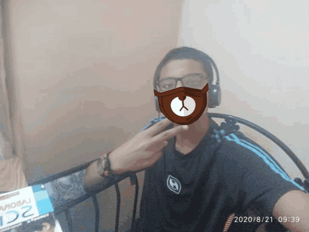 a man wearing headphones and a mask with a bear on it