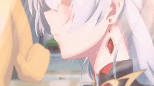 a close up of a girl 's ear with a red stone