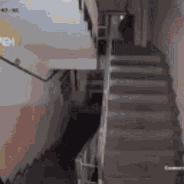 a person is walking up a set of stairs in a dark room .
