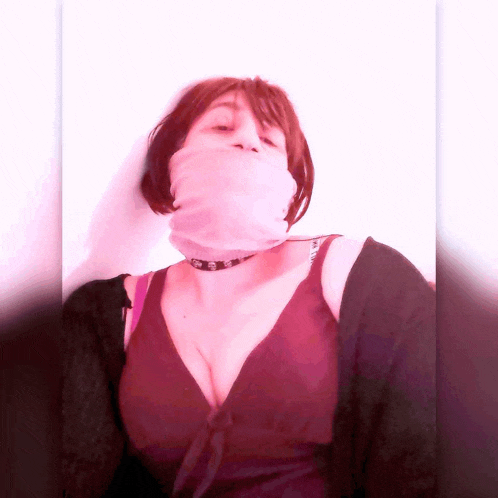 a woman wearing a choker necklace and a pink scarf around her neck