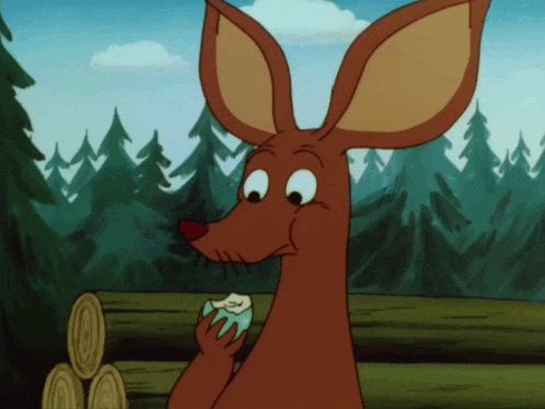 a cartoon kangaroo eating a piece of apple in a forest