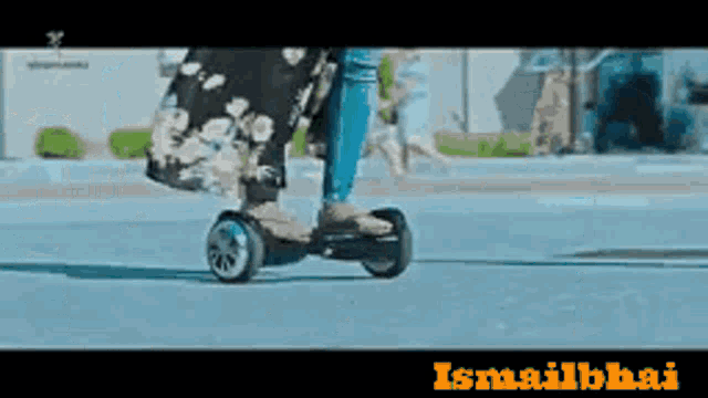 a person is riding a hover board with the word ismailbai on the bottom right