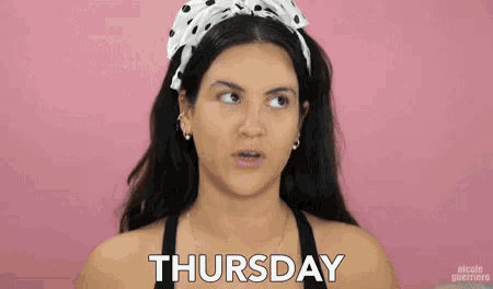 a woman wearing a polka dot headband is looking up at the word thursday
