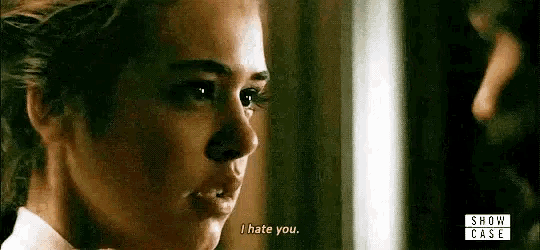 a close up of a woman 's face with the words `` i hate you '' written on her face .