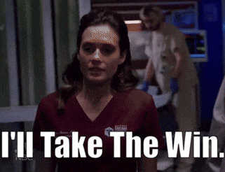 a woman in a scrub top with the words i 'll take the win