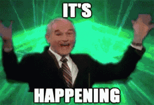 a man in a suit and tie with his arms in the air and the words it 's happening