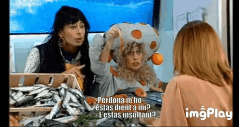 a woman in a mushroom costume is talking to two other women .