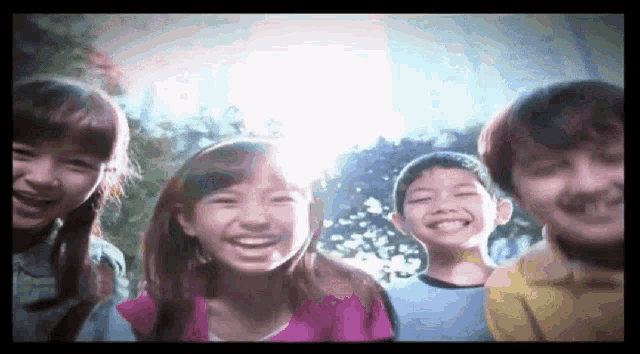 a group of children are smiling for a picture