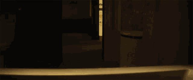 a dark room with a few lights on and a toilet