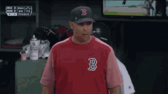 a man wearing a red boston red sox shirt