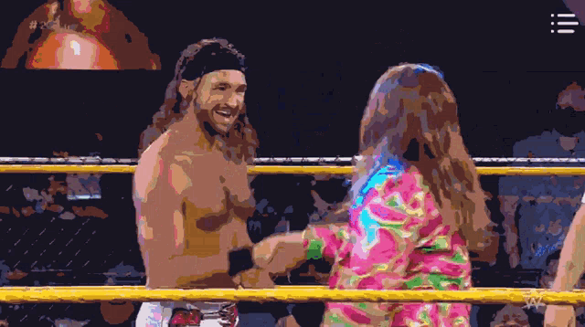 a man and a woman are shaking hands in a wrestling ring with the letters w on the bottom right