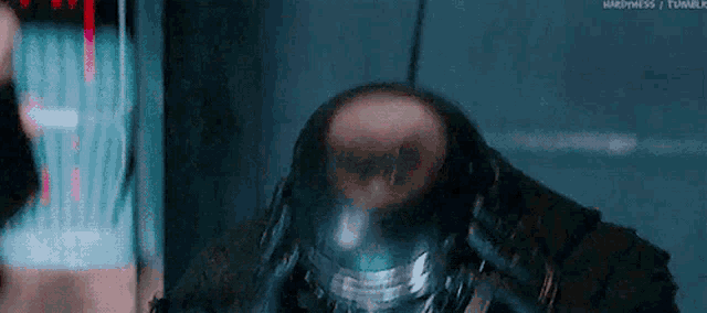 a close up of a man wearing a helmet with a skull on it .