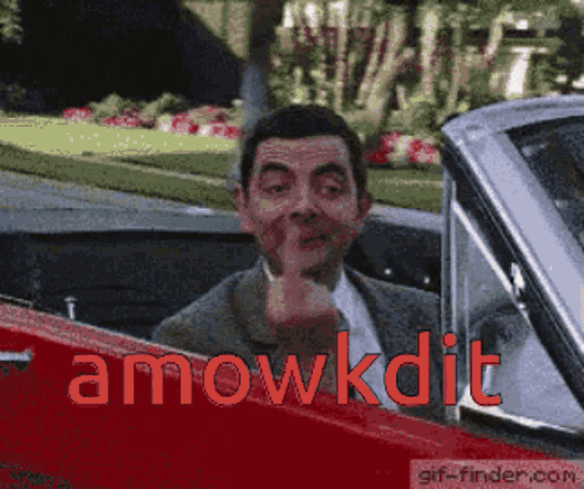 a man in a car with the words amowkdit written on the side