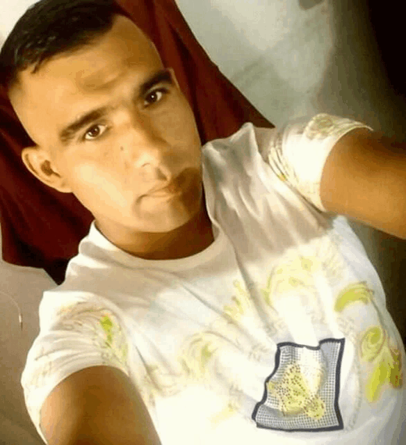 a man taking a selfie with a white shirt with the number 21 on it