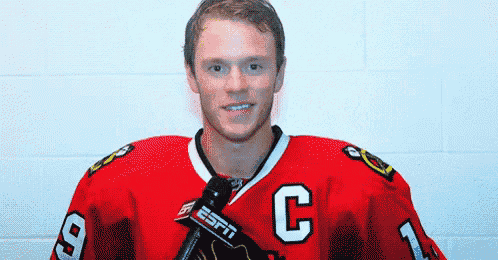 a hockey player wearing a jersey with the letter c on it