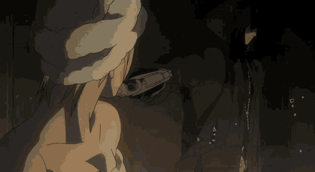 a person is pointing a gun at another person in a dark area