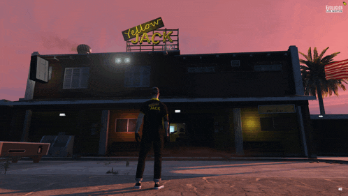 a man is standing in front of a yellow jack restaurant