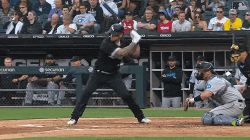 a baseball player is swinging at a pitch in front of a sign that says securan