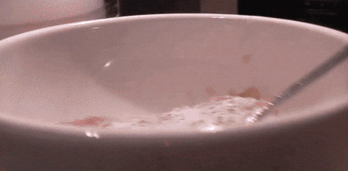 a close up of a bowl of cereal with a spoon