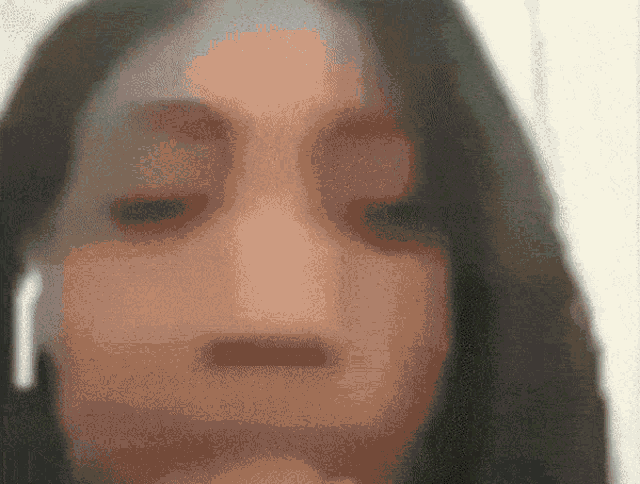a close up of a woman 's face with a blurred background