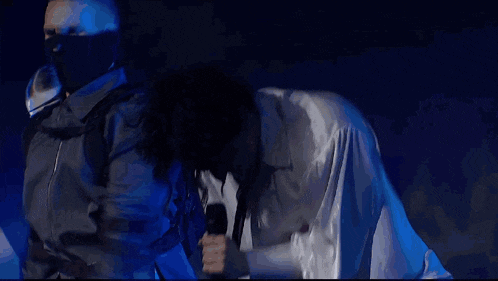 a man in a white shirt and tie is kneeling down