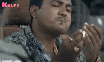 a man is eating something with a toothpick and the word kulfy is on the bottom of the screen