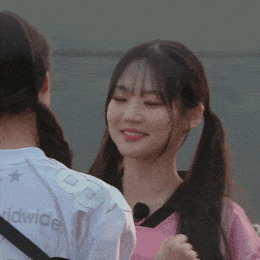 a girl with pigtails is wearing a white shirt with the number 8 on it