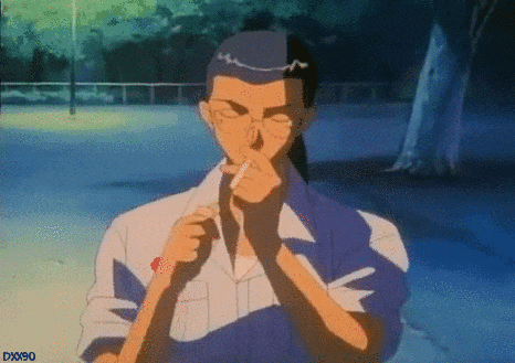 a man in a blue and white shirt is smoking a cigarette in a park at night