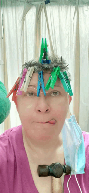 a woman with clothes pins on her head and a mask on her neck