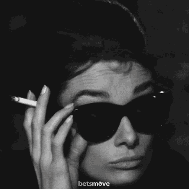 a black and white photo of a woman smoking a cigarette with a betsmove logo in the corner