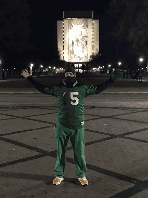 a person wearing a green jersey with the number 15 on it