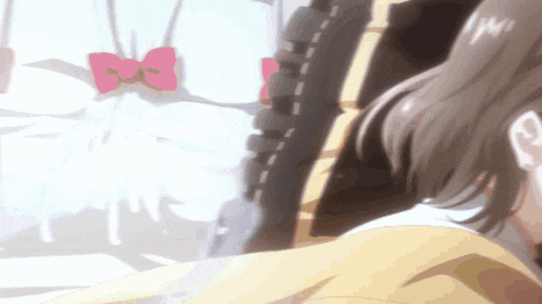 a close up of a girl 's face with a pink bow on her shirt