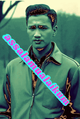 a man wearing a green jacket with a pink stripe that says " assalamualaikum " on it