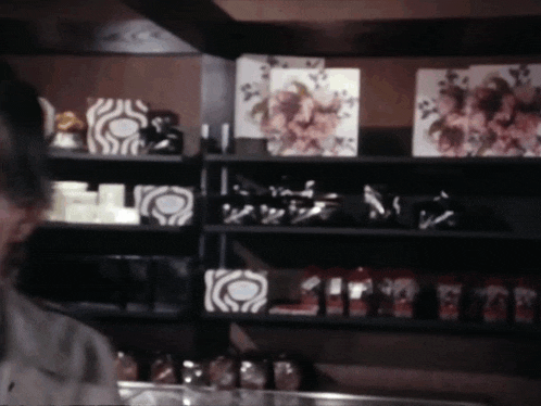 a man is standing in front of a shelf with a zebra print