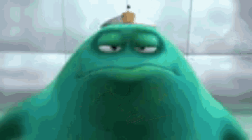 a green cartoon character with a sad look on his face