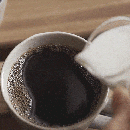 Pouring Milk Into Coffee Two Plaid Aprons GIF - Pouring Milk Into Coffee Two Plaid Aprons Adding Milk GIFs