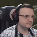 a man wearing headphones is sitting in a chair .