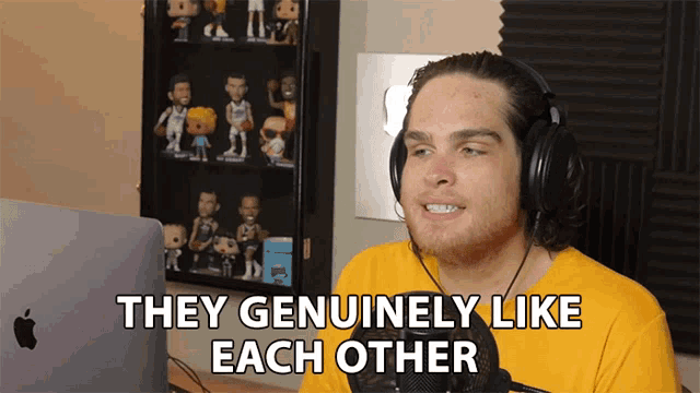 a man wearing headphones and a yellow shirt says " they genuinely like each other "