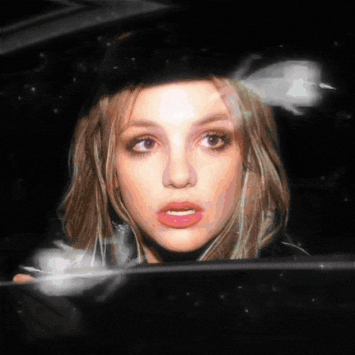a close up of a woman 's face behind a car window