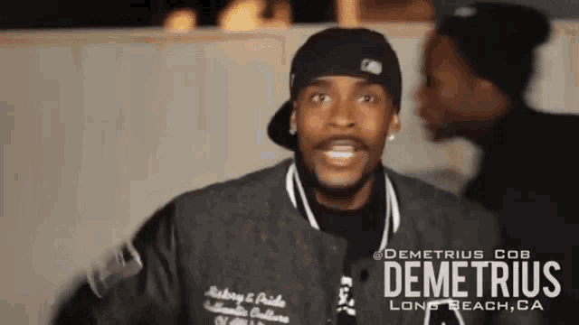 a man wearing a jacket that says demetrius cob long beach ca