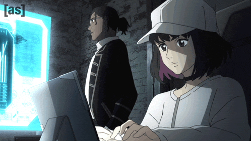 a man and a woman are looking at a computer screen with the letters [ as ] on it