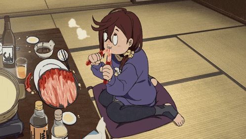a girl is sitting on the floor eating a slice of meat