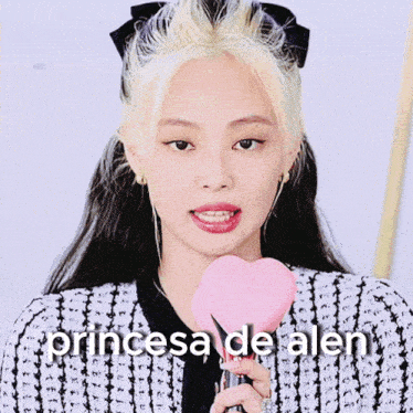 a woman holding a microphone with the words princesa de alem written above her